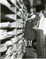 Librarian Marilynn Collins and Frank Holloway in the Armour Research Foundation library, Illinois Institute of Technology, Chicago, Illinois, ca. 1947-1949