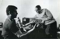 Dr. Daniel Graupe and an assistant using a computerized arm prothesis, Illinois Institute of Technology, Chicago, Illinois, 1980s