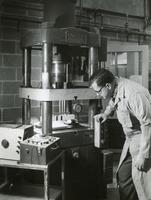 Seymour Bortz using a hydraulic press, Armour Research Foundation, Illinois Institute of Technology, Chicago, ca. 1950s