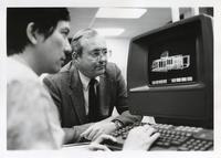 Chuck Owen and unidentified Institute of Design professor at a computer, Illinois Institute of Technology, Chicago, Illinois, ca. 1979-1987