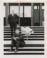 Takatsugu Sugiyama and Jay Doblin with Sugiyama's Ribbon Chair on the steps of S.R. Crown Hall, Illinois Institute of Technology, Chicago, Illinois, ca. 1960