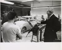 Jay Doblin with unidentified Institute of Design students and a car chassis, Illinois Institute of Technology, Chicago, Illinois, ca. 1955-1965