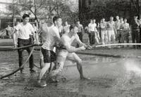 Students using a firehose in "The Bog," Illinois Institute of Technology, Chicago, Illinois, ca. 1960
